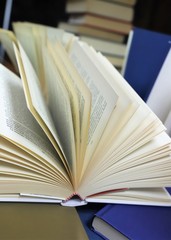 composition of open and closed books in the foreground