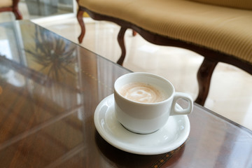Coffee in a white cup and saucer. The hotel is all-inclusive. Break in the waiting room.