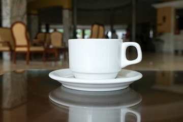 Coffee or tea in a white cup and saucer. The hotel is all-inclusive. Break in the waiting room.