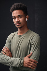 Fototapeta premium Image of masculine african american guy using earpods
