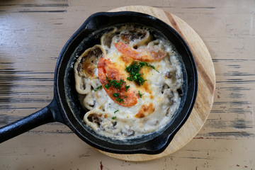 Lazy dumplings with mushrooms and cheese. Baked food in a pan.