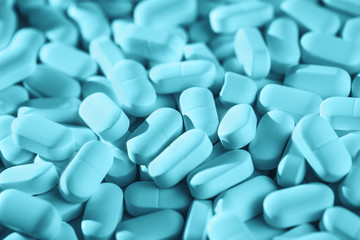 Fototapeta na wymiar Blue monochrome Background of pile of tablets on the table. Healthcare and medicine concept drugs safety consumption or misuse with copy space