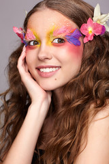 Naklejka premium Female with hand near face and fashion feather eyelashes make-up