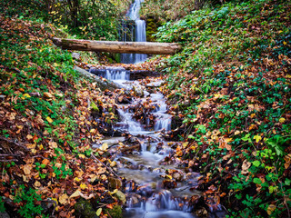 Small waterfall with foliage in Garmisch-Partenkirchen in autumn
