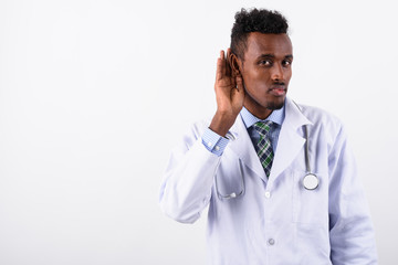 Young bearded African man doctor against white background