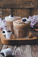 Happy  Halloween monster, pumpkin spice latte with big marshmallow eye