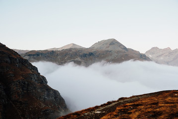 Beautiful view with mountain peaks in the clouds.