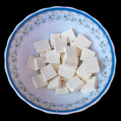 Paneer or cottage cheese cube close up, Isolated on Black background.