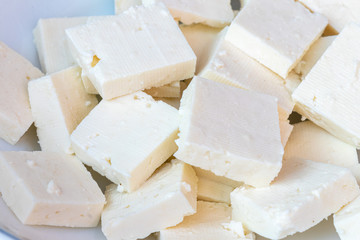 Paneer or cottage cheese cube close up, slice pieces of homemade fresh raw panner.