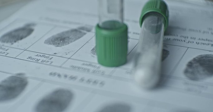 Fingerprints card and test tubes close up in motion, CSI.