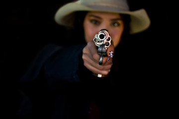 cowgirl with a gun.life style of cowgirl.beautiful girl cowboy with a gun.