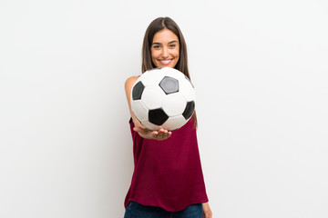 Young woman over isolated white background holding a soccer ball