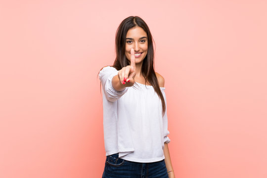 Young woman over isolated pink background showing and lifting a finger