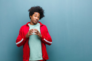 young black sports man scheming and conspiring, thinking devious tricks and cheats, cunning and...
