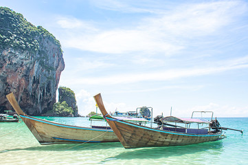 Lots of boat tours and tourists on the beach Background island at Phra Nang Cave Beach , Krabi in Thailand.