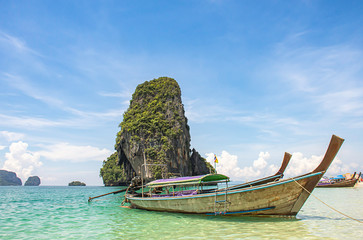 Lots of boat tours and tourists on the beach Background island at Phra Nang Cave Beach , Krabi in Thailand.