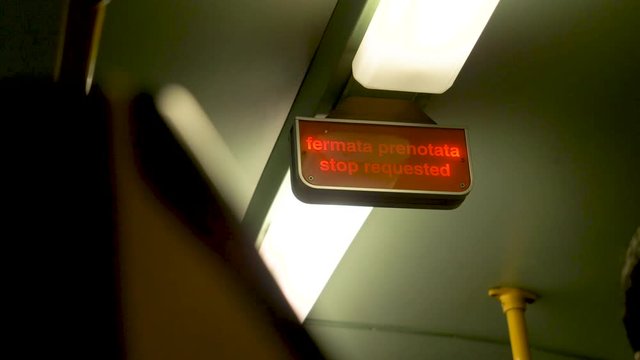 Flashing red light saying "stop requested" inside of a train. in Italian and English. Train in Rome, Italy