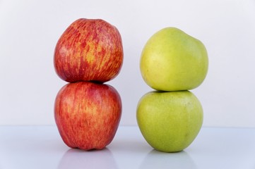 Red and green apples on white background. 