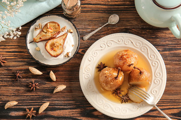 Different sweet cooked pears on wooden table