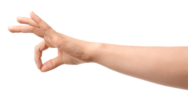 Hand of woman showing OK gesture on white background