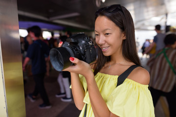 Young beautiful tourist woman exploring the city of Bangkok