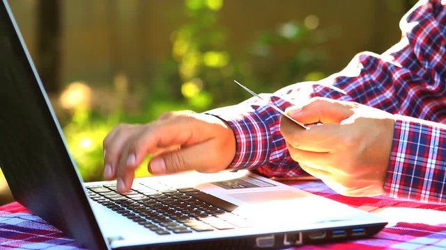 Man use credit card shopping online, indoor  Chiangmai Thailand