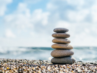 Stones balance on beach with copy space for text or design. Stones pyramid as zen, harmony, balance concept