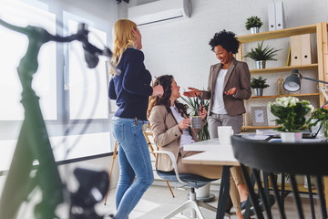 Obraz premium Women only business office. Woman entrepreneur. Diverse business team discussing work in their creative office.