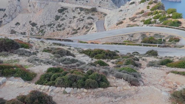 A steady view of cap formentor street  with limestone mountains and zic zac narrow roads from resort balcony, A romantic getaway nestled along the coast of the Mediterranean. Mallorca