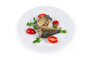 Baked slices of Atlantic mackerel with greens and tomatoes