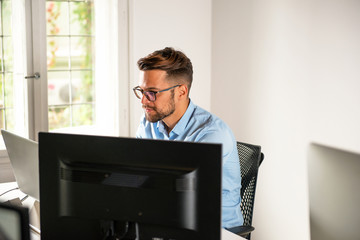 Young man working at his office	