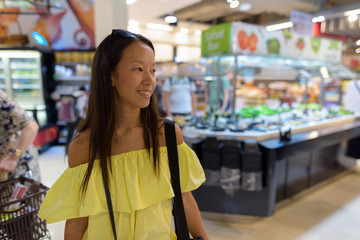 Young beautiful tourist woman exploring the city of Bangkok