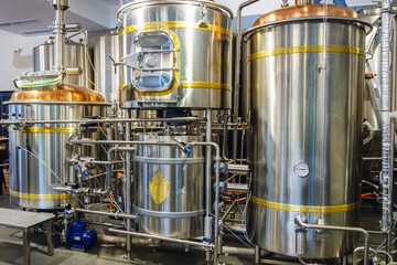 Stainless steel brewing tanks and equipment, iron reservoirs and pipes in modern beer factory