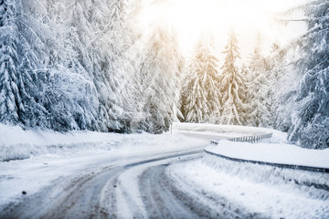 Winter beautiful snowy road snow or landscape forest and trees covered with snow. Yellow sun shine...