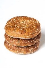 Round rye bread roll on white background