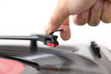 Close up of a man putting a Vinyl on turntable.