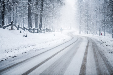 Winter snowy or calamity road in forest mountains. Beautiful snow road. © Milan