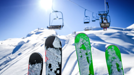 Ski lift in the dolomity mountains. Skis in the air at winter day. Cinque torri location.