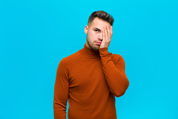 young hispanic man feeling bored, frustrated and sleepy after a tiresome, dull and tedious task,...