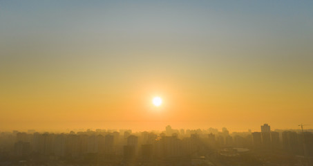 Fototapeta na wymiar Sunrise over the metropolis Beautiful cityscape early in the morning. Aerial drone shot