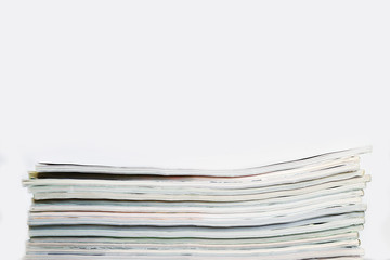 Stack of magazines on a table on a white background