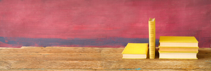 Hardback books on wooden table.Reading, learning, education, literature, panoramic, good copy space