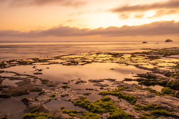 Seascape. Golden hour of sunset at the beach. Ocean low tide. Horizontal background banner. Nyang Nyang beach, Bali, Indonesia.