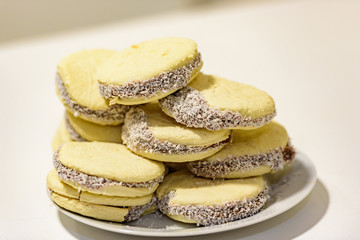 Mate and Delicious Argentinian and uruguayan cookies alfajores with cream on paper close-up on the table. Horizontal. Mate drink traditional in Uruguay, Argentina, Paraguay and Brazil.