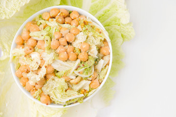 Vegetarian salad of chickpeas and cabbage on a light background. Proper nutrition. Copy space