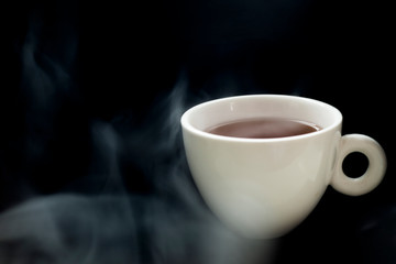Obraz na płótnie Canvas Coffee cup and smoke on a black background