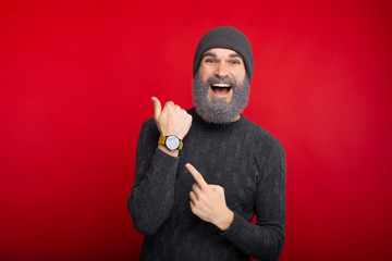Amazed man with white beard pointing at watch