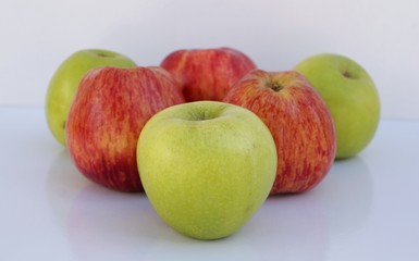 Green and red apples on white background. 