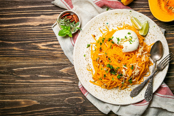 Butternut squash noodles with mozzarela, pecans, herbs, copy space