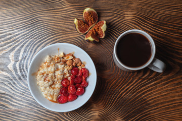 Breakfast oatmeal porridge with fruits berries and coffee cup. Healthy breakfast concept.